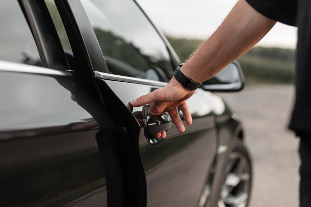 Man checks for a VIN number by opening his door