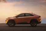 ATA Curvv's distinctive coupe-SUV silhouette, highlighting its aerodynamic design and high ground clearance against a dramatic sky.