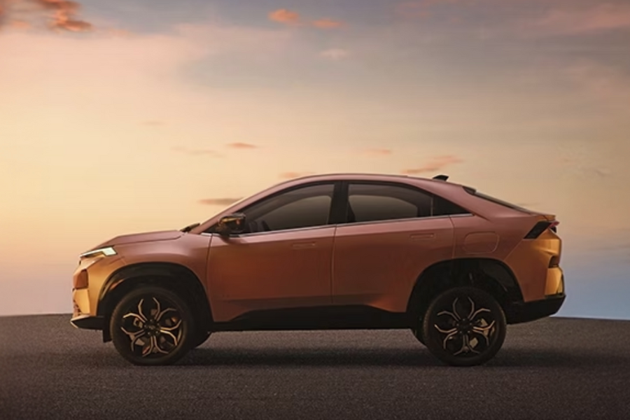 ATA Curvv's distinctive coupe-SUV silhouette, highlighting its aerodynamic design and high ground clearance against a dramatic sky.