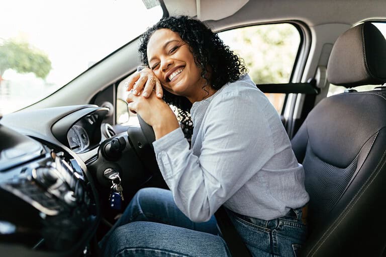 Woman is excited about her second-hand car purchase