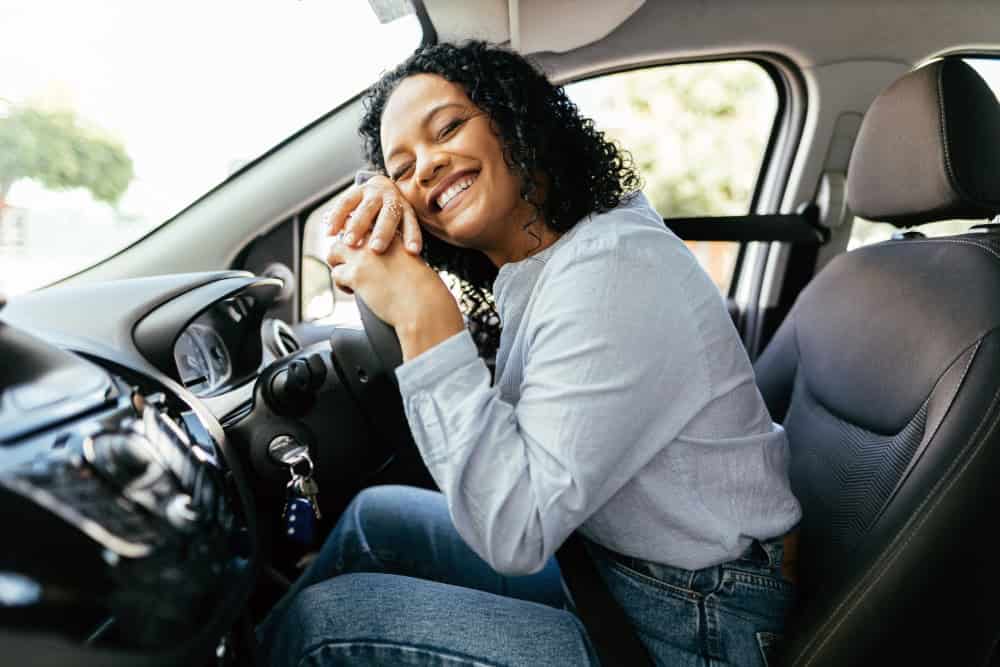 Woman is excited about her second-hand car purchase