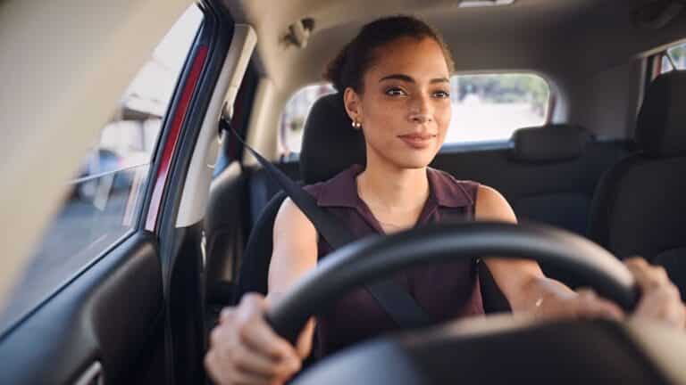 Woman test drives a used car for sale