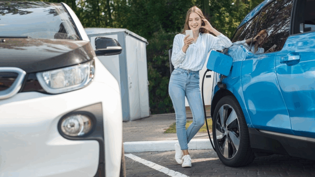 Woman charges her electric car along her journey